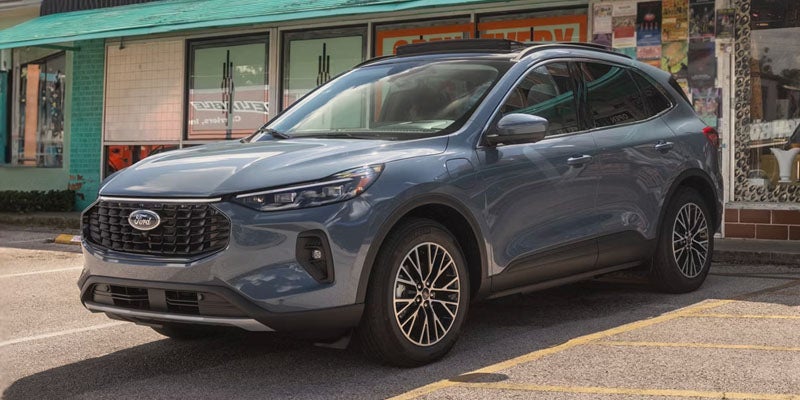 Ford SUV parked outside a local storefront in an urban setting 